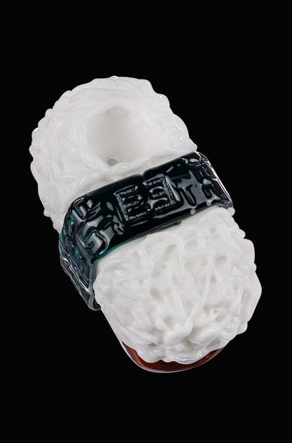 A close-up, angled view of the Empire Glassworks Spam Musubi Sushi Hand Pipe, showcasing its detailed, colorful design.