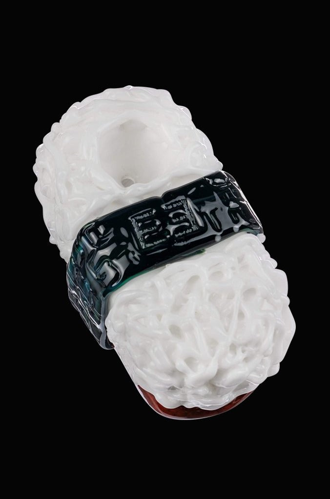 A close-up, angled view of the Empire Glassworks Spam Musubi Sushi Hand Pipe, showcasing its detailed, colorful design.
