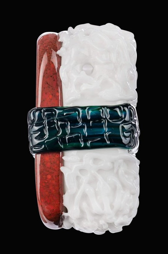 A close-up shows the Empire Glassworks Spam Musubi Sushi Hand Pipe, resembling a colorful sushi roll with a detailed, sculpted glass design.
