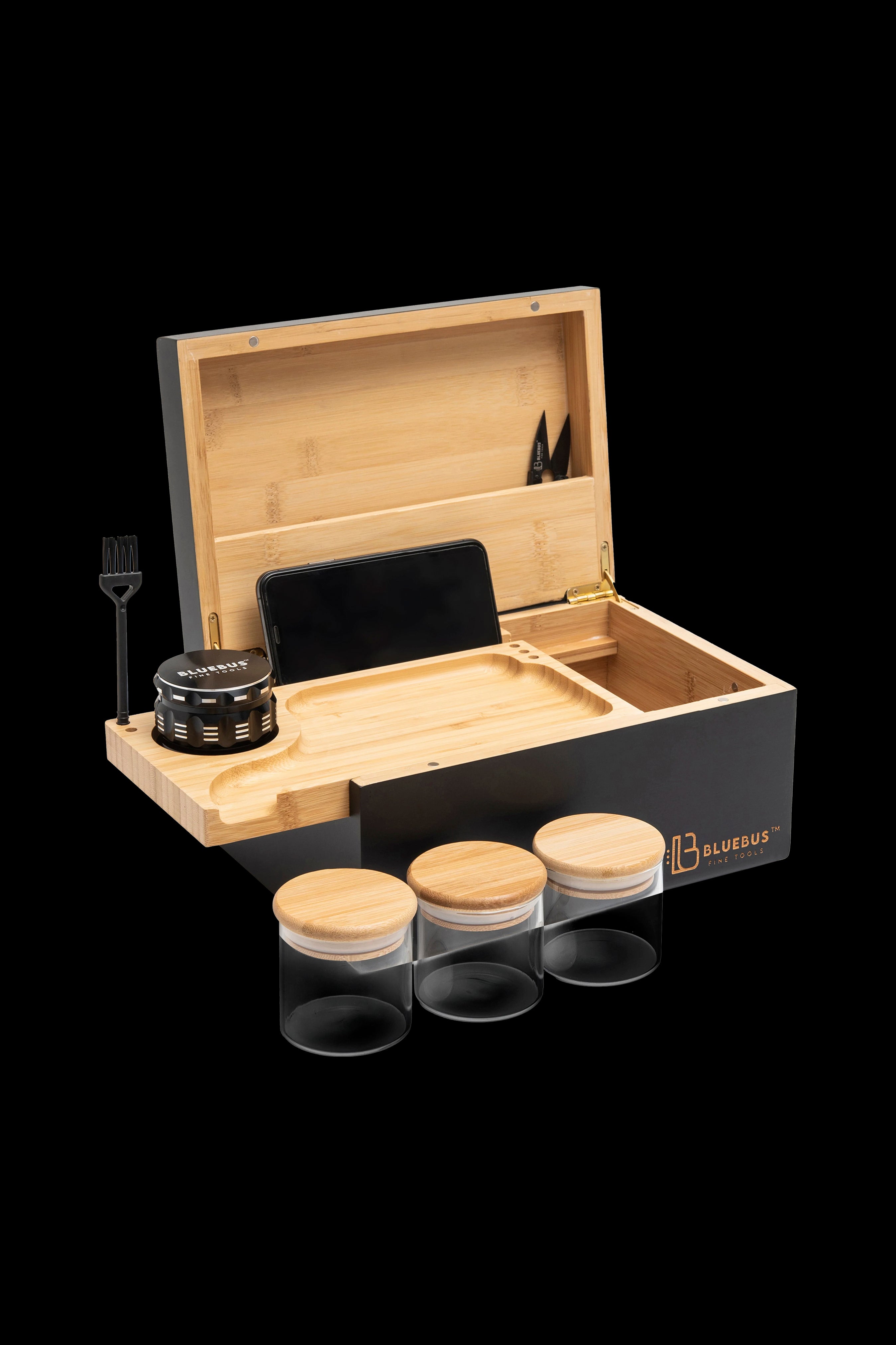 Wooden cannabis accessory box with grinder, jars, and tools inside.
