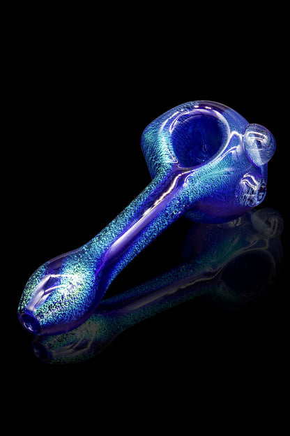 Blue glass pipe with textured surface, studio shot.