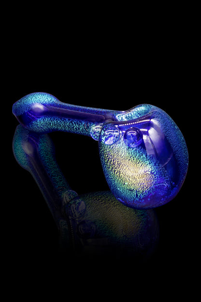 Iridescent blue glass water pipe with textured surface.