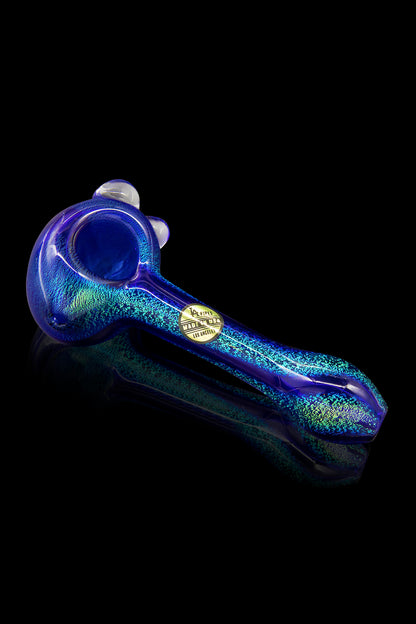 A vibrant blue glass pipe with iridescent glitter, isolated on a black background.