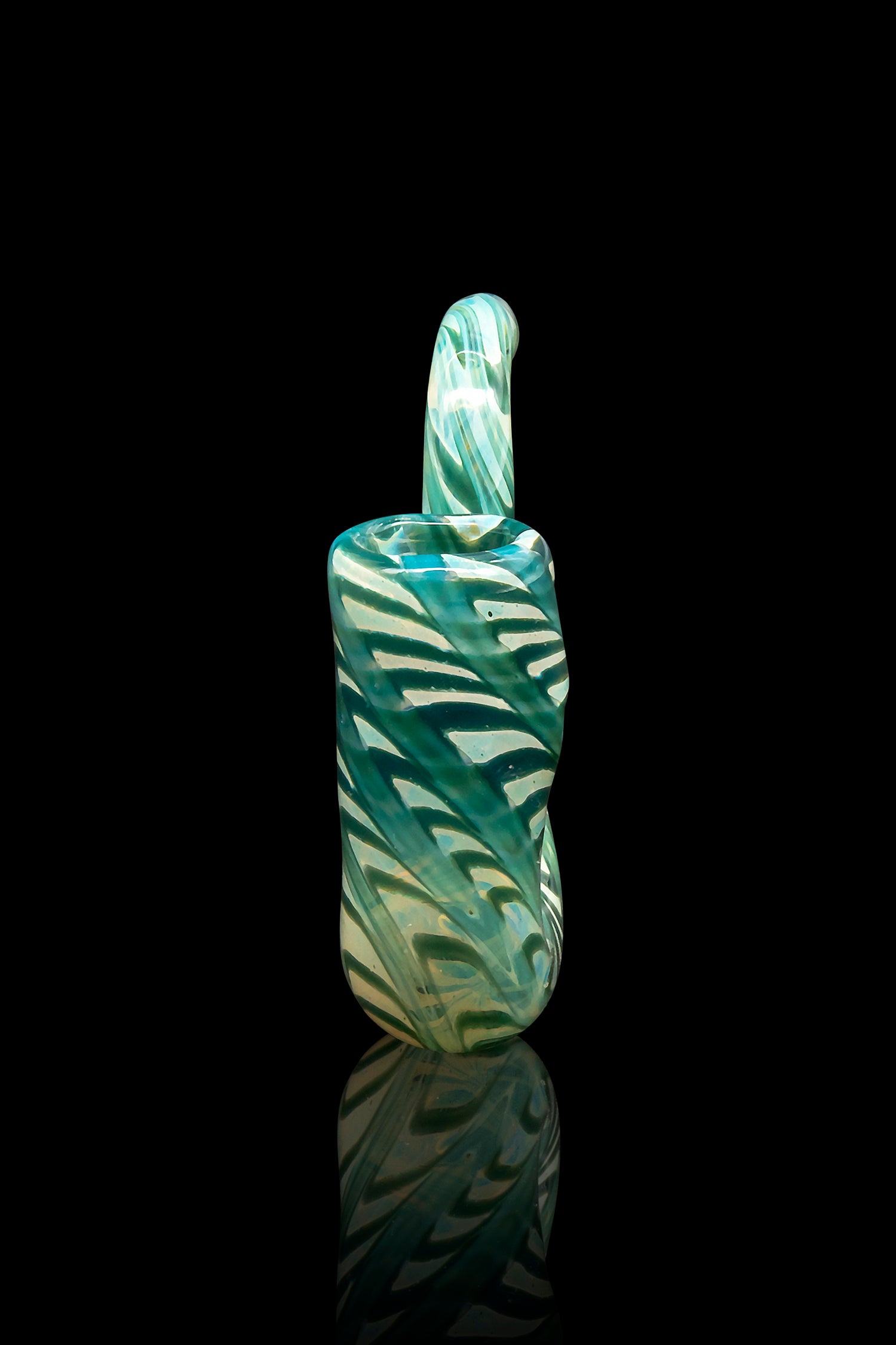 Green and teal swirled glass dab rig with a looped handle, reflected on a dark surface.