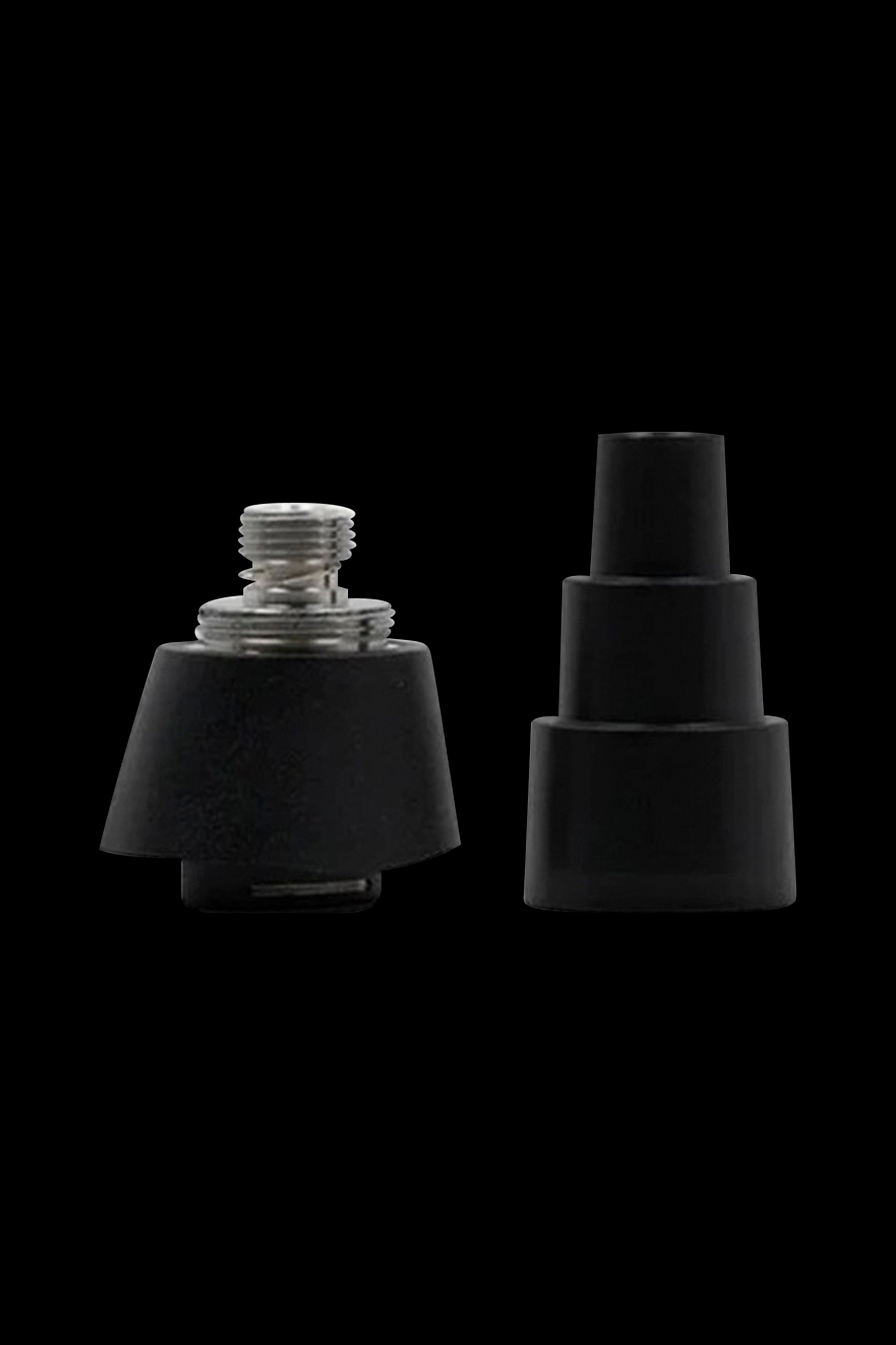 Black cannabis concentrate coils and carb caps isolated on a black background.