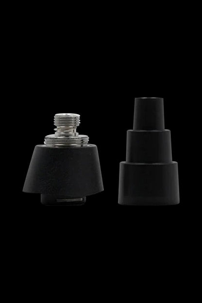 Black cannabis concentrate coils and carb caps isolated on a black background.