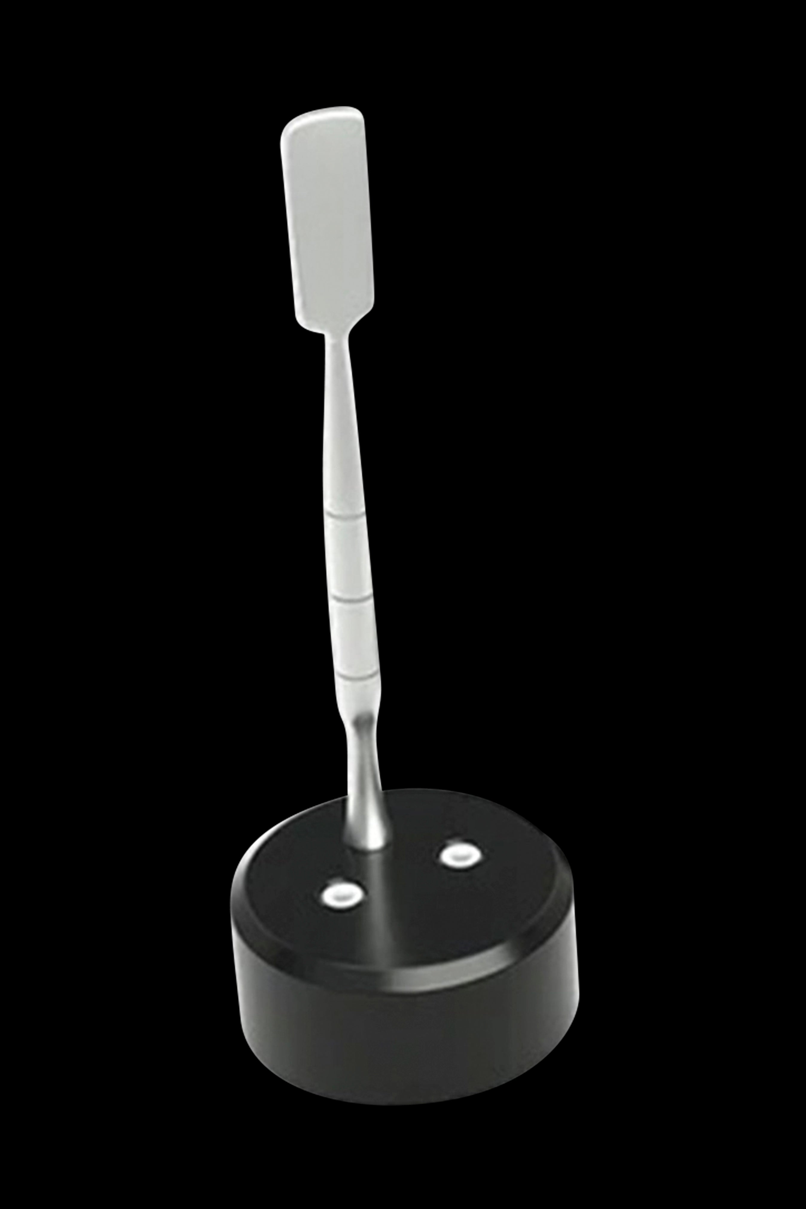 Silver dab tool resting in a black base with two small indentations.