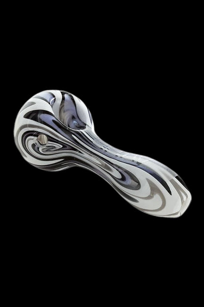 Glass pipe with black and white swirling pattern.