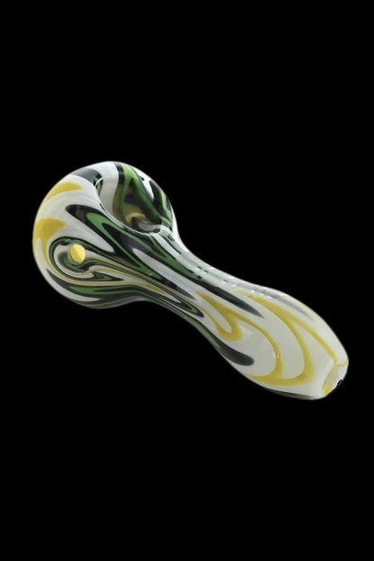 Glass pipe with green and yellow swirls against a black background.