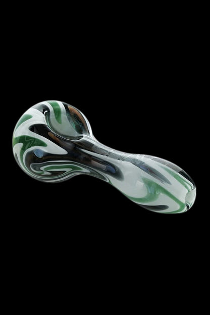 Glass pipe with swirling green and white patterns on a black background.