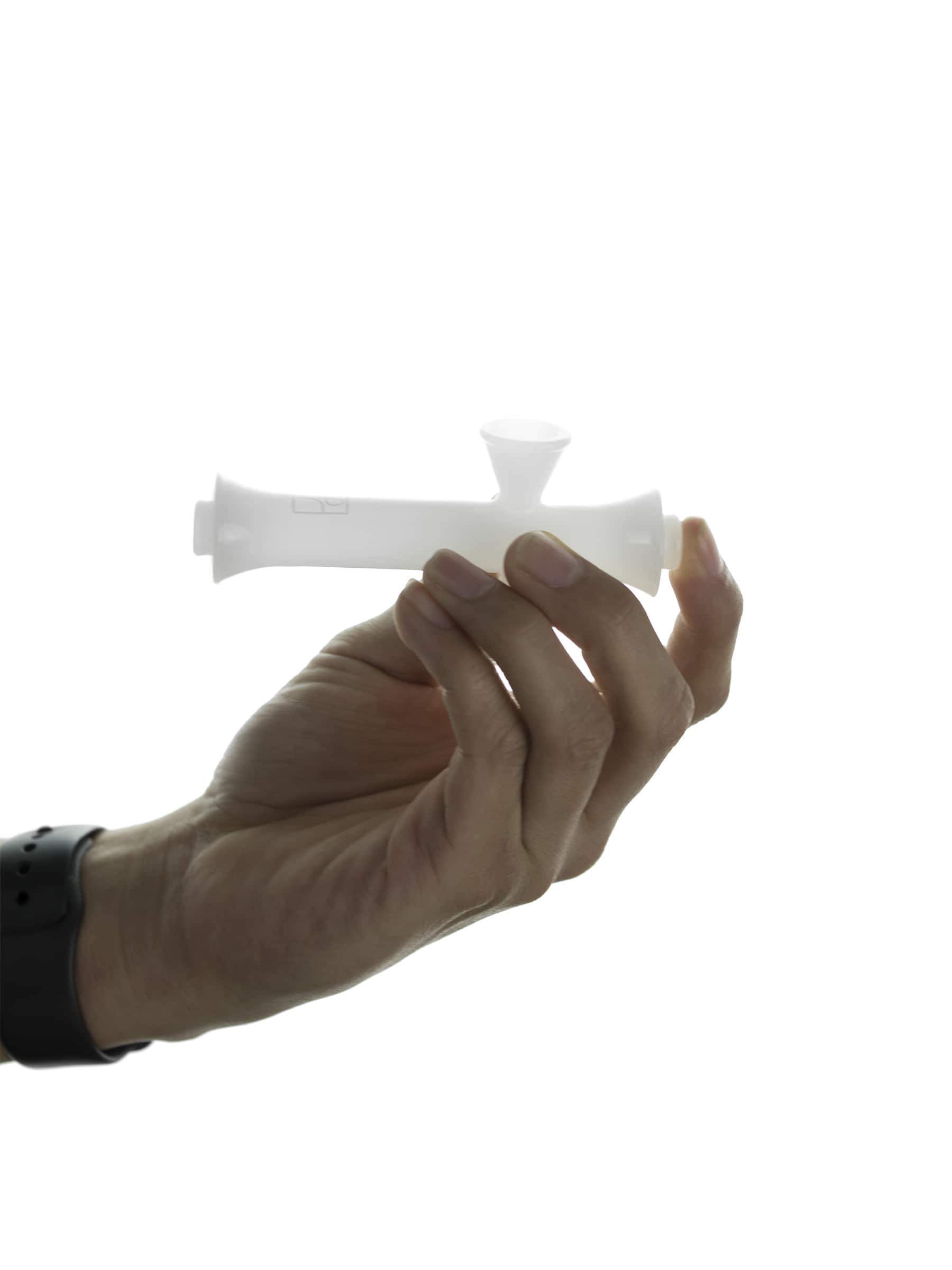 A hand holds the Jane West Cloud White Steamroller, showcasing its sleek, white design against a plain backdrop.