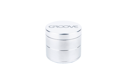 A studio shot of the four-piece Aerospaced Groove Aluminum Grinders, stacked and gleaming with a metallic finish.