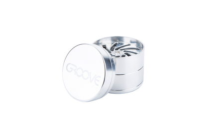 A slightly angled view of the Aerospaced Groove 4-Piece Aluminum Grinders, showing its metallic finish and circular design.