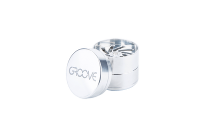 A close-up shot of the open Aerospaced Groove 4-Piece Aluminum Grinders, displaying the multi-tiered grinding mechanism.