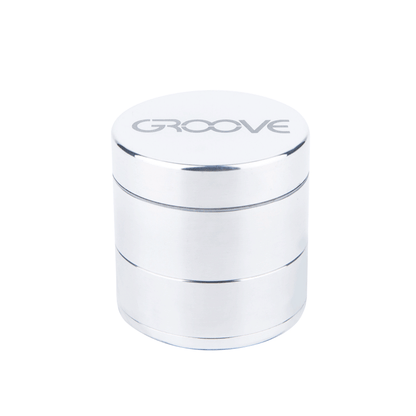 A front view of the Aerospaced Groove 4-Piece Aluminum Grinders, showing its silver metallic finish and layered cylindrical design.