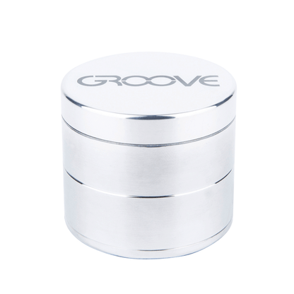 A close-up, angled view of the Aerospaced Groove 4-Piece Aluminum Grinders, showcasing its metallic finish and cylindrical shape.