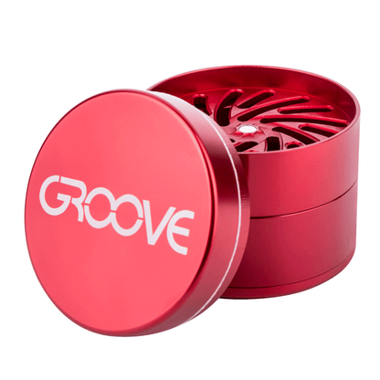 An open Aerospaced Groove 4-Piece Aluminum Grinder shown from a high angle, revealing its multi-tiered interior.