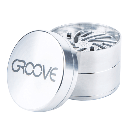 A partially disassembled Aerospaced Groove 4-Piece Aluminum Grinders, showing its multi-tiered design from a slightly elevated angle.
