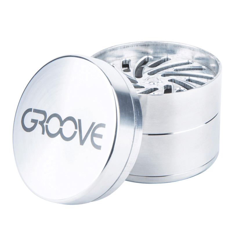 A partially disassembled Aerospaced Groove 4-Piece Aluminum Grinders, showing its multi-tiered design from a slightly elevated angle.