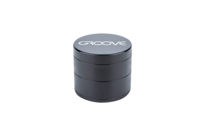 A close-up shot of the stacked, four-piece Aerospaced Groove Aluminum Grinders, showcasing their metallic finish.