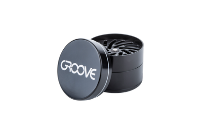 A close-up of the Aerospaced Groove 4-Piece Aluminum Grinders, showing its circular, multi-tiered design against a neutral background.