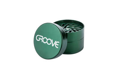 A slightly open Aerospaced Groove 4-Piece Aluminum Grinder, captured in a close-up, angled shot against a plain white backdrop.