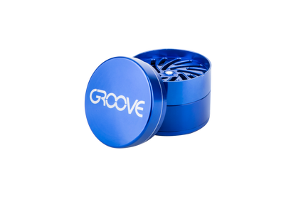 A close-up, angled view of the Aerospaced Groove 4-Piece Aluminum Grinders, showcasing its metallic blue finish and circular design.