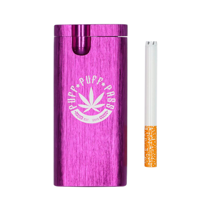 A side view of the Aluminum Dugout - Large, showcasing its metallic purple finish and a partially smoked cigarette inserted into the top.