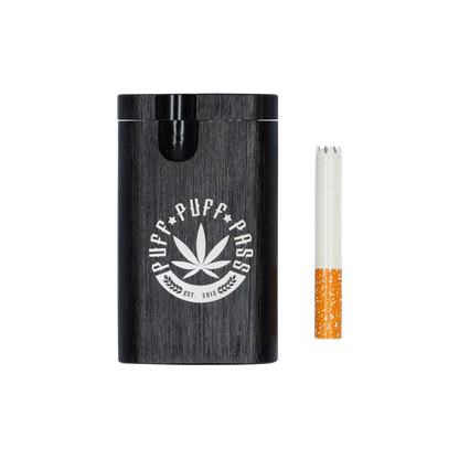 A close-up shot of the Aluminum Dugout, showing a one-piece metal container with a visible cigarette resting inside.