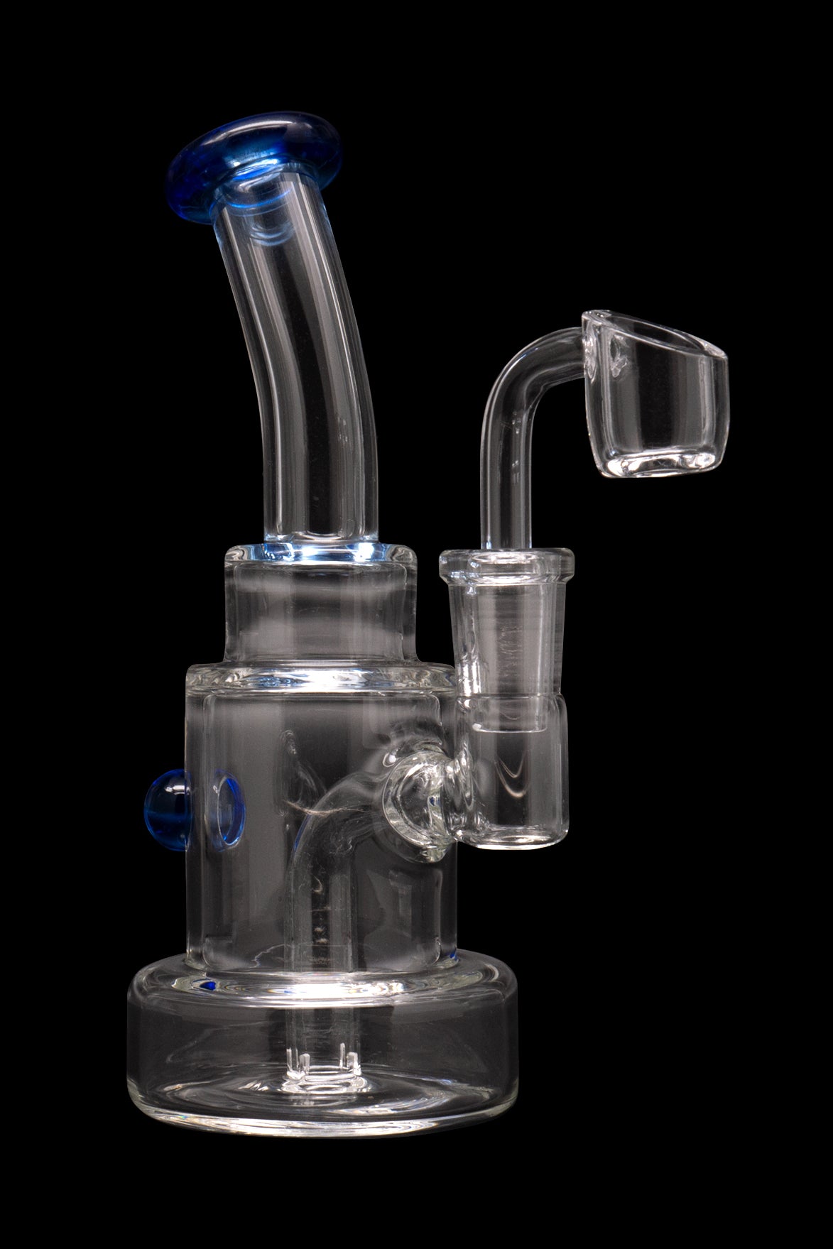 Clear glass dab rig with blue accents and a quartz banger.