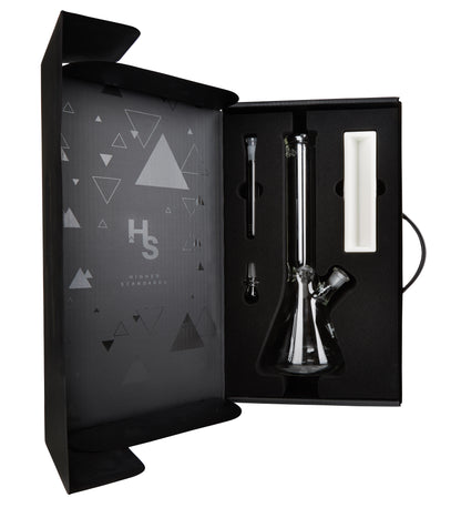 Front view of the Higher Standards Heavy Duty Beaker, showcasing its clear glass construction against a dark, geometric backdrop.