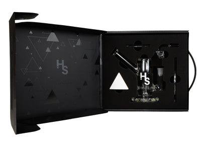 A studio shot displays the Higher Standards Heavy Duty Rig against a dark background with subtle triangular patterns.