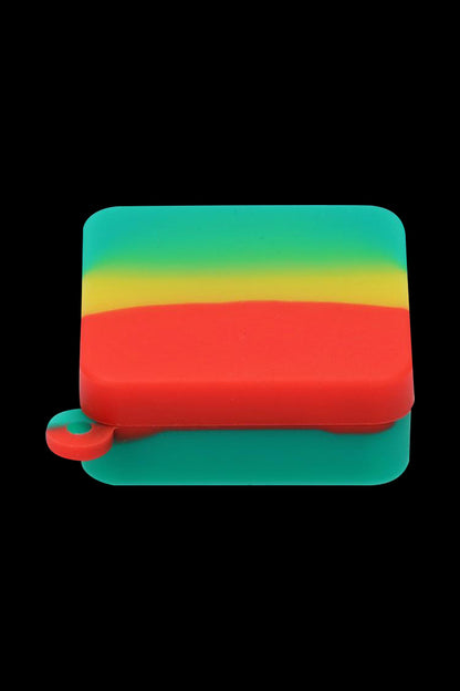 Close-up front view of the Silicone Square Keychain Stash Container showing a yellow-green-red layered silicone square against a black background.