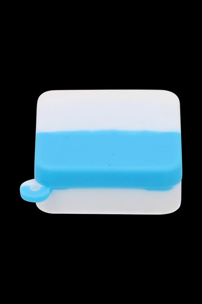 Top-down view of a blue and white Silicone Square Keychain Stash Container centered on a black background, showing its rounded square shape and small keyloop.