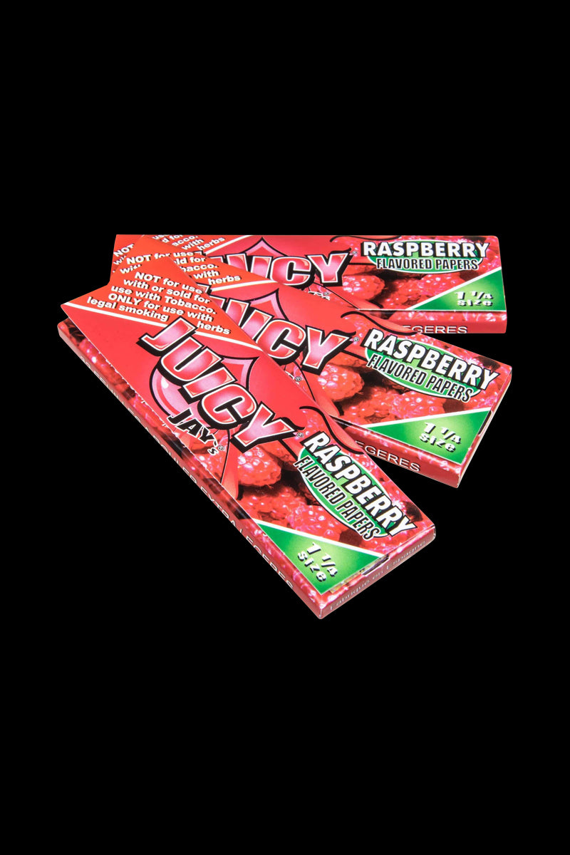 A brightly lit, close-up view of Juicy Jay's Classic Size Flavored Rolling Papers with a vibrant raspberry design.