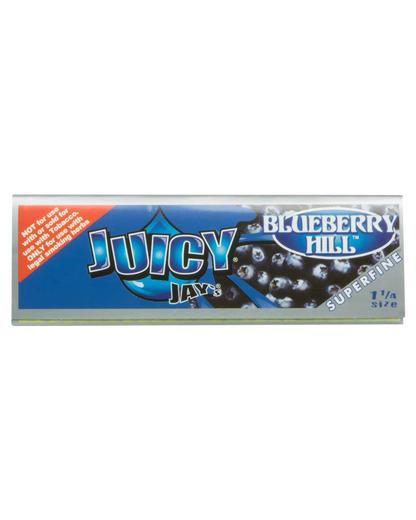 A close-up of Juicy Jay's Superfine 1-1/4" flavored rolling papers packaging with a vibrant blue and berry-themed design.