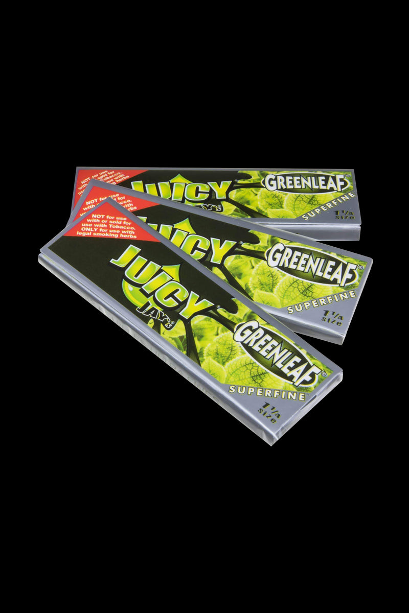 A stack of Juicy Jay's Superfine 1-1/4" flavored rolling papers, photographed from a slight angle against a plain background.