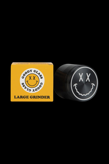 A close-up of the Goody Big Face Travel Size Grinder, showing its circular design against a plain black background.