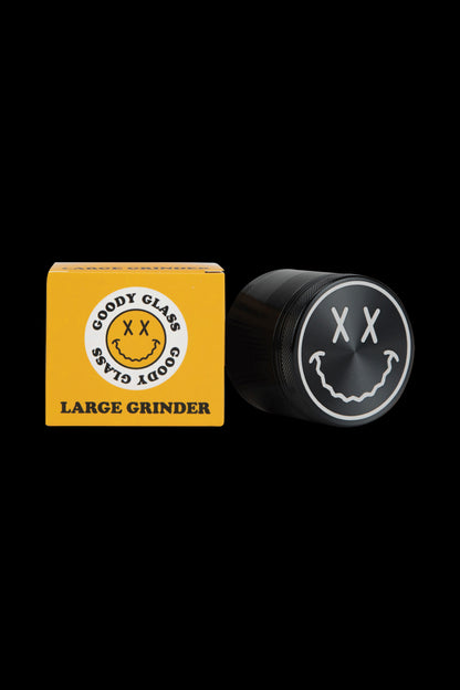 Front view of the Goody Big Face Grinder, featuring a textured black finish and a large, circular face design.