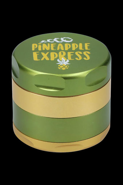 Front view of the Puff Puff Pass-Pineapple Express Strain Grinder, a silver, multi-tiered metal grinder against a dark backdrop.