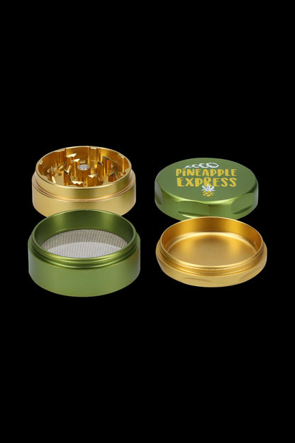 A top-down view of the Puff Puff Pass-Pineapple Express Strain Grinder, showcasing the metallic, multi-tiered design.