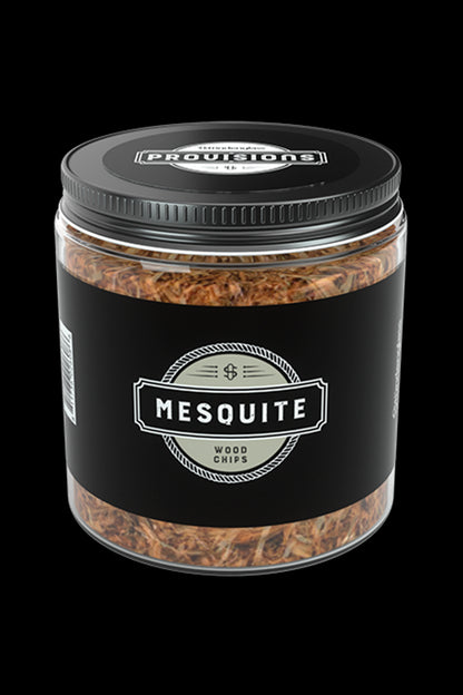 A glass jar labeled “Mesquite Wood Chips” with a cannabis leaf symbol, suggesting use with cannabis smoking or vaporization.