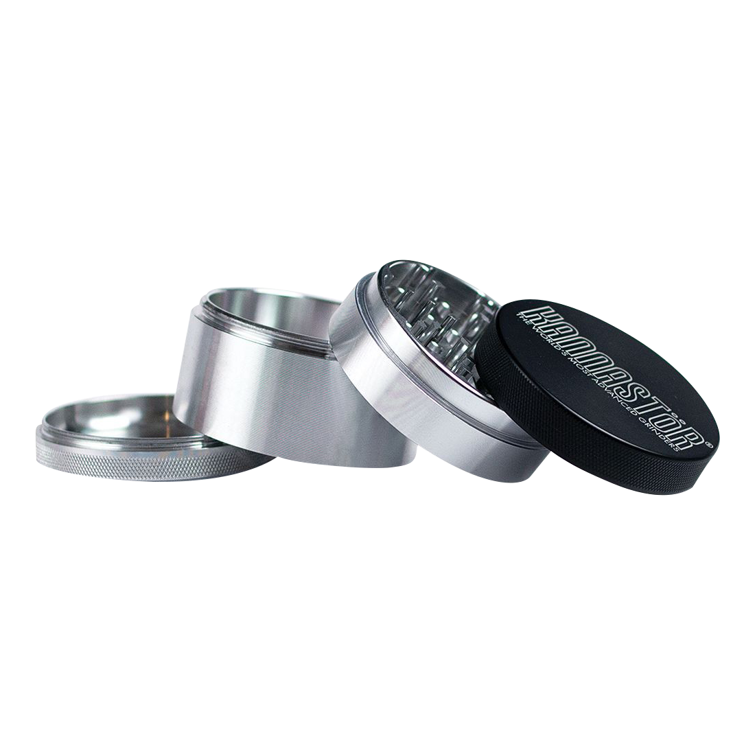 A slightly angled, close-up view of the disassembled 4-piece Kannastor Solid Body Grinder, showcasing its metallic components.