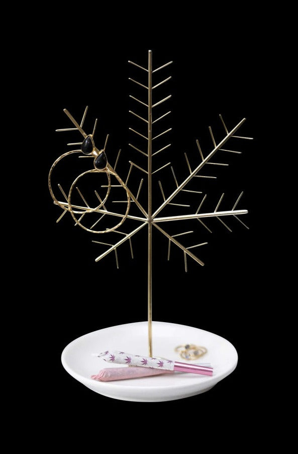A slightly angled view of the My Bud Vase Cannabis Leaf Jewelry Tree, displaying a delicate, metallic tree form rising from a circular base.