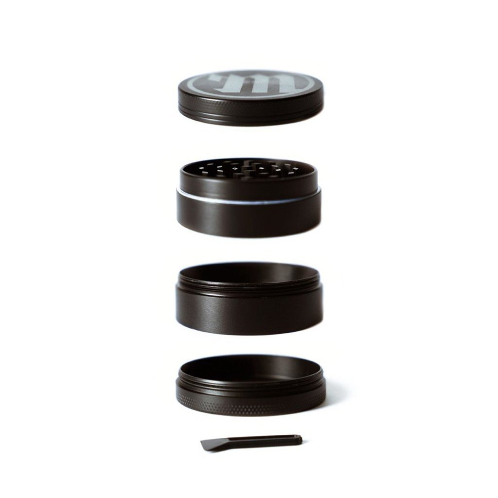 A disassembled view of the Myster Black 4 Piece Grinder, showing its four black components stacked vertically against a white background.