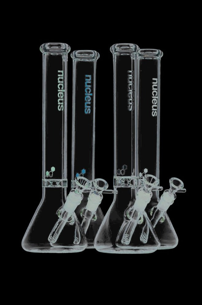 A front view of the Nucleus 12" Beaker Bong with Donut Style Ice Catcher, displaying its clear glass construction on a black background.
