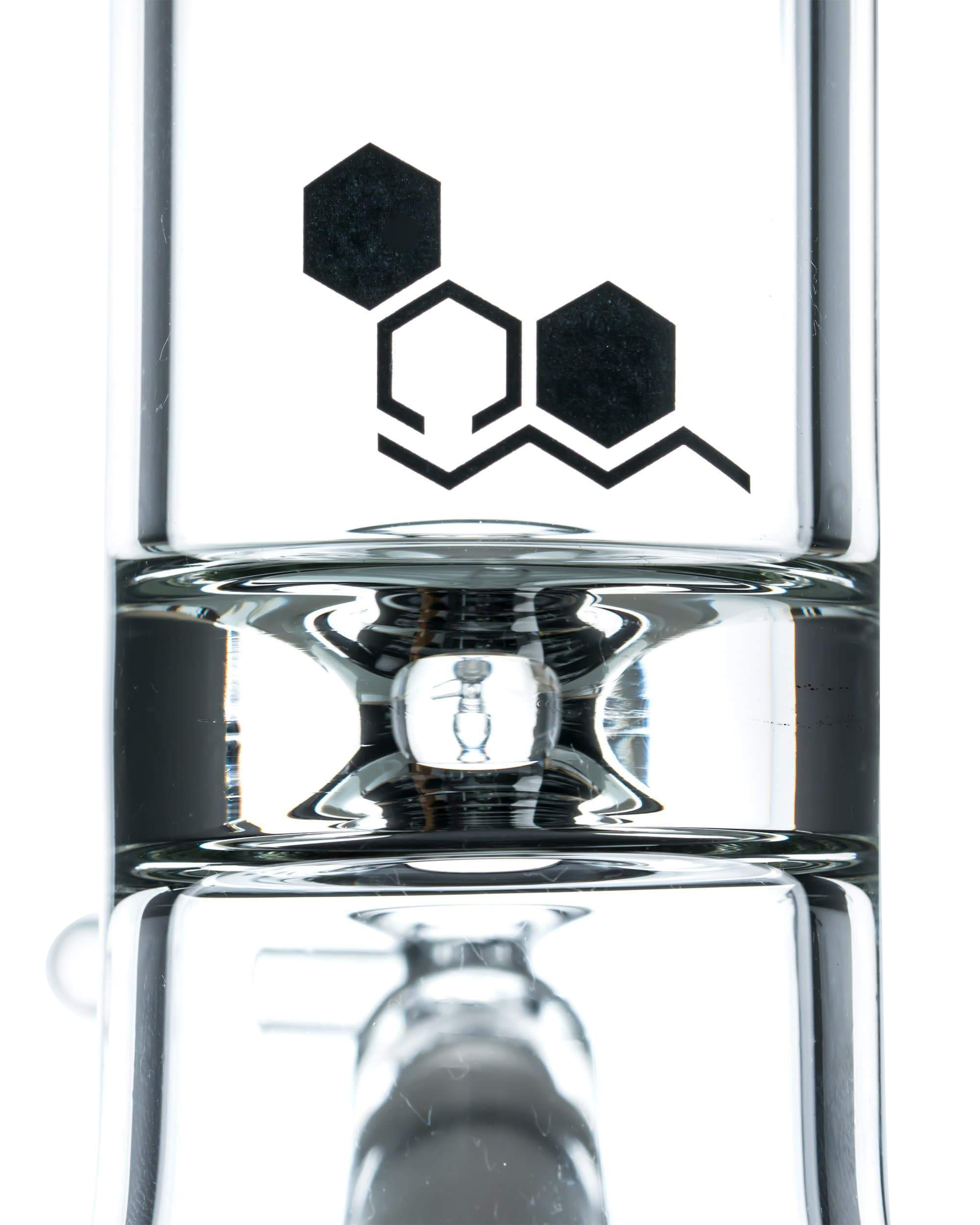 A front view of the Nucleus 12" Beaker Bong with Donut Style Ice Catcher, showcasing its clear glass construction and simple cylindrical shape.