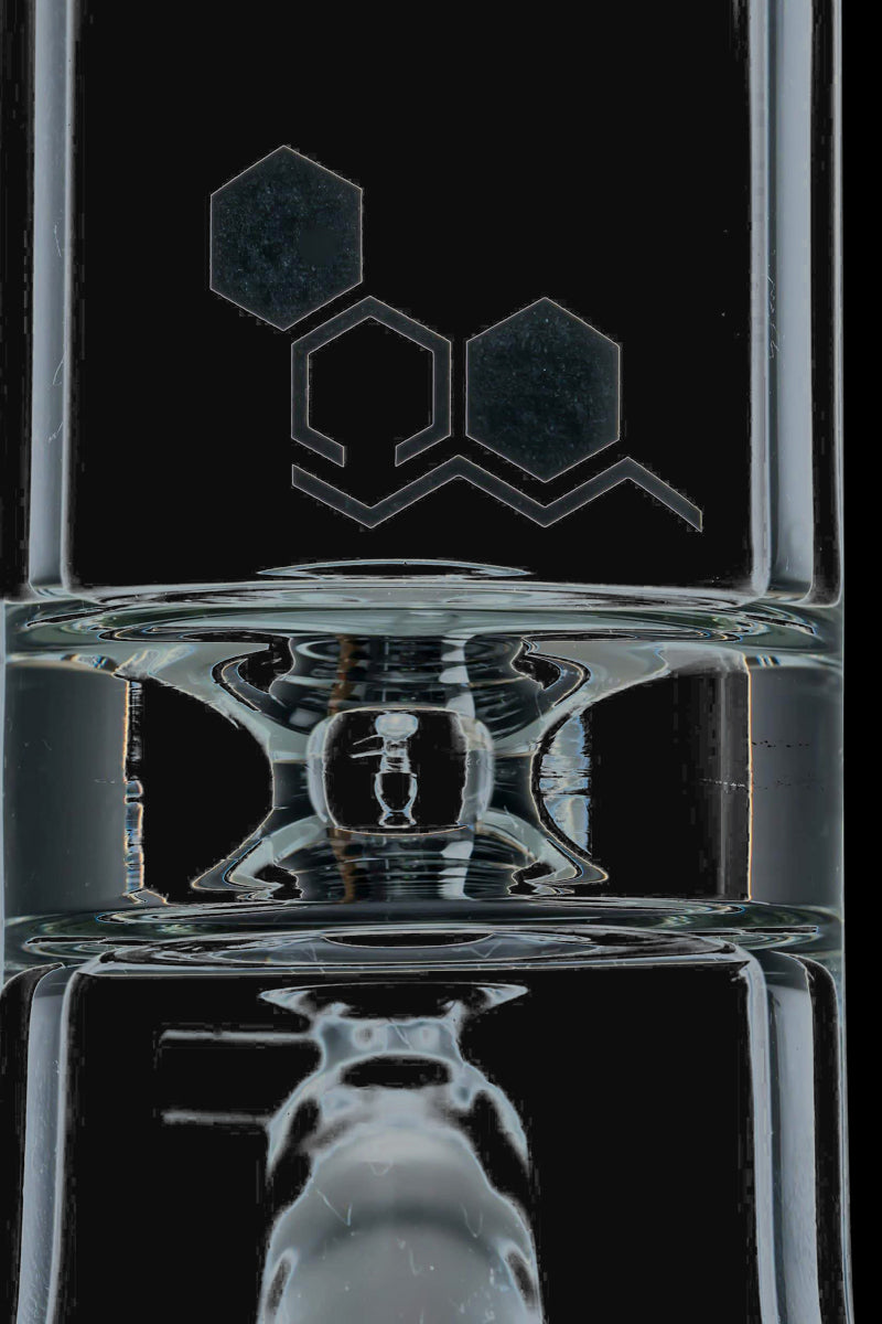 Front view of the Nucleus 12" Beaker Bong with Donut Style Ice Catcher, showing its clear glass construction and cylindrical shape.