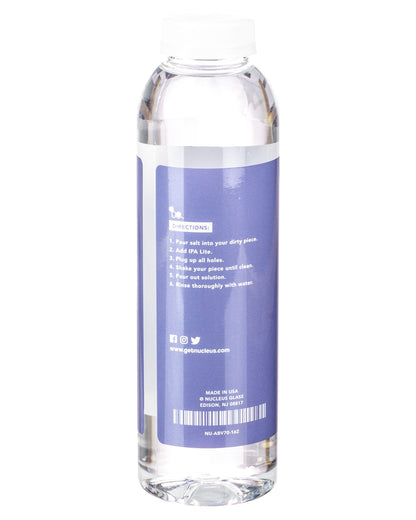 Clear plastic bottle filled with cleaning solution, labeled with instructions for cleaning cannabis pipes and accessories.