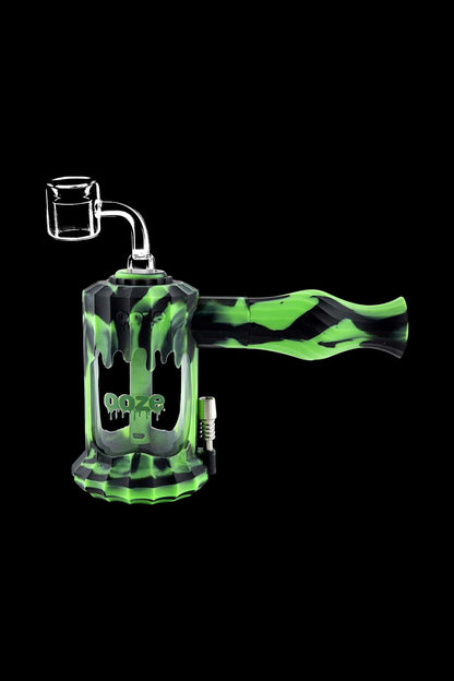 A studio shot of the Clobb 4 in 1 Silicone Pipe, featuring a green, textured design against a dark background.